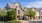 a large house with trees in front of it