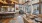 a large kitchen with a bar and chairs