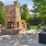 a patio with chairs and a fireplace