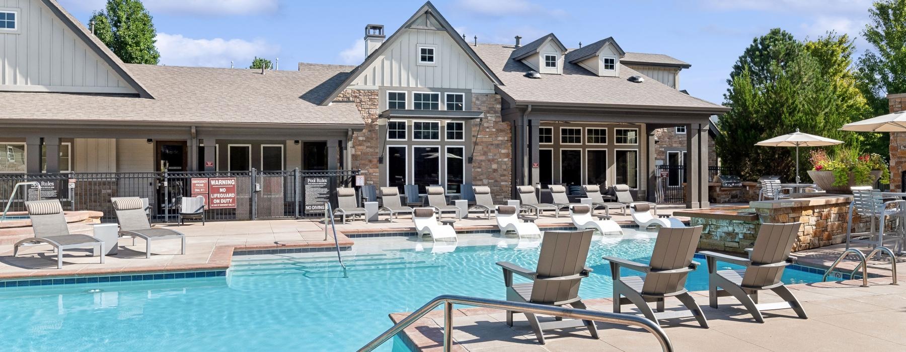 a swimming pool with chairs around it