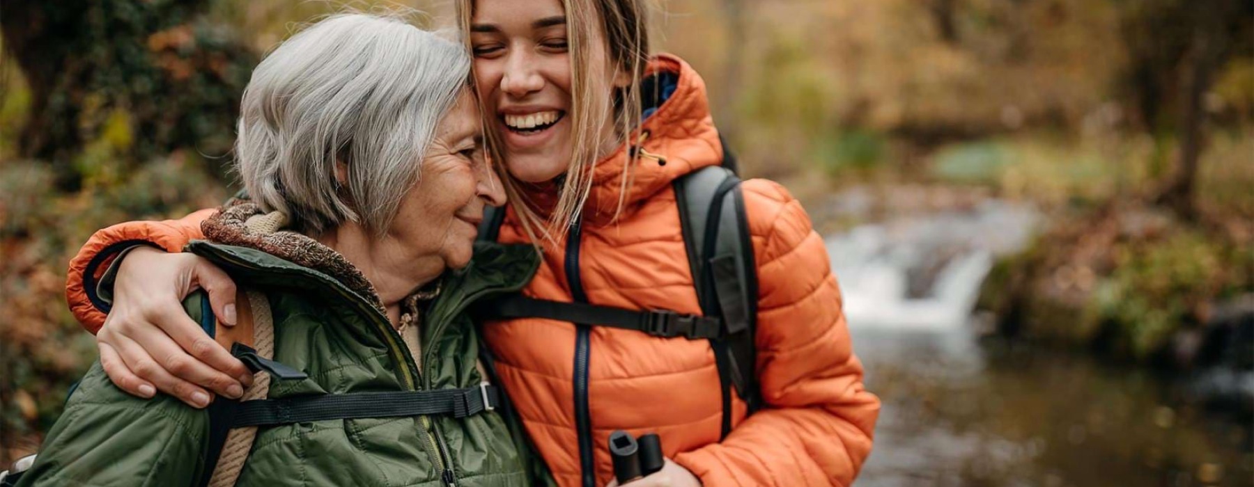 a couple of women smiling while hiking