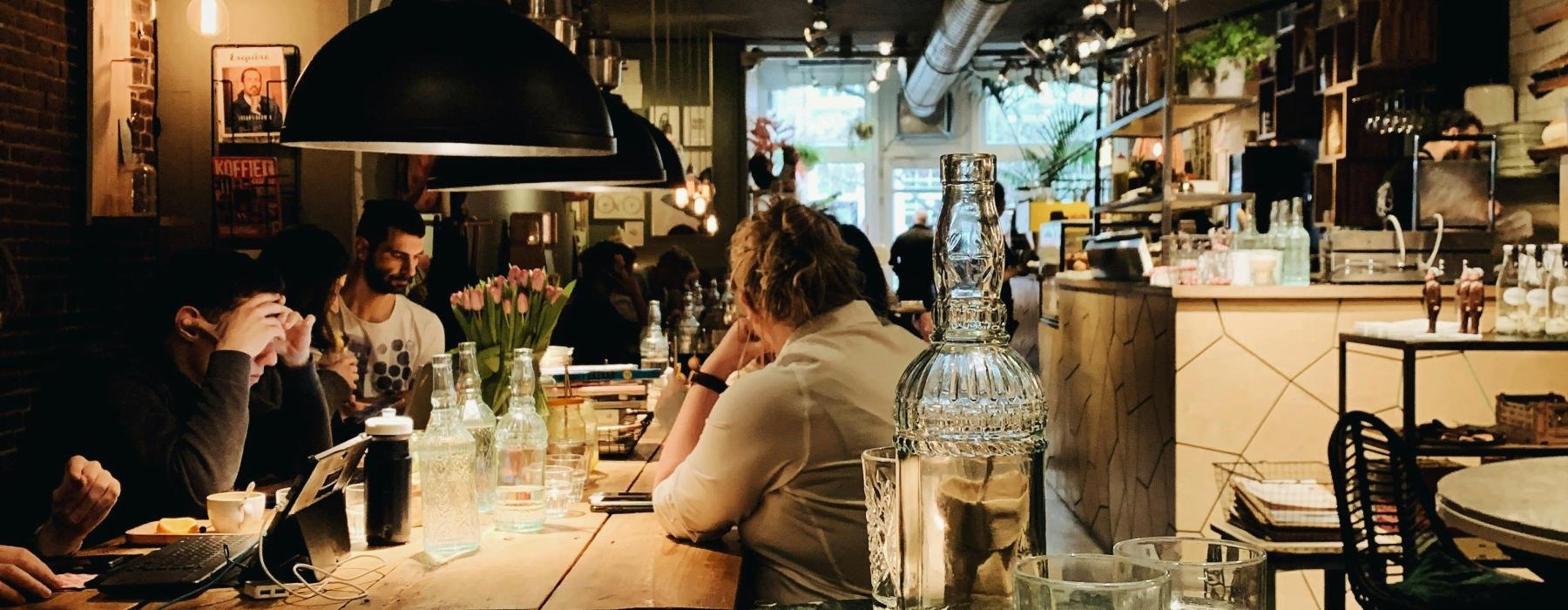 people sitting at tables in a restaurant