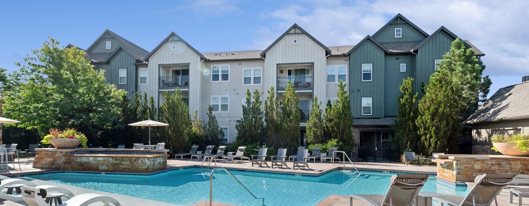 a swimming pool in front of a large house