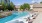 a swimming pool with chairs around it