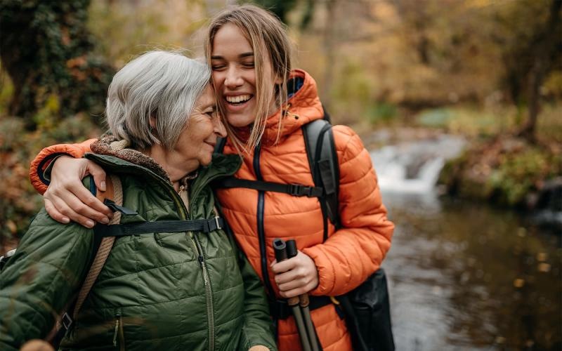 a couple of women smiling while hiking