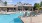 a swimming pool with chairs around it
